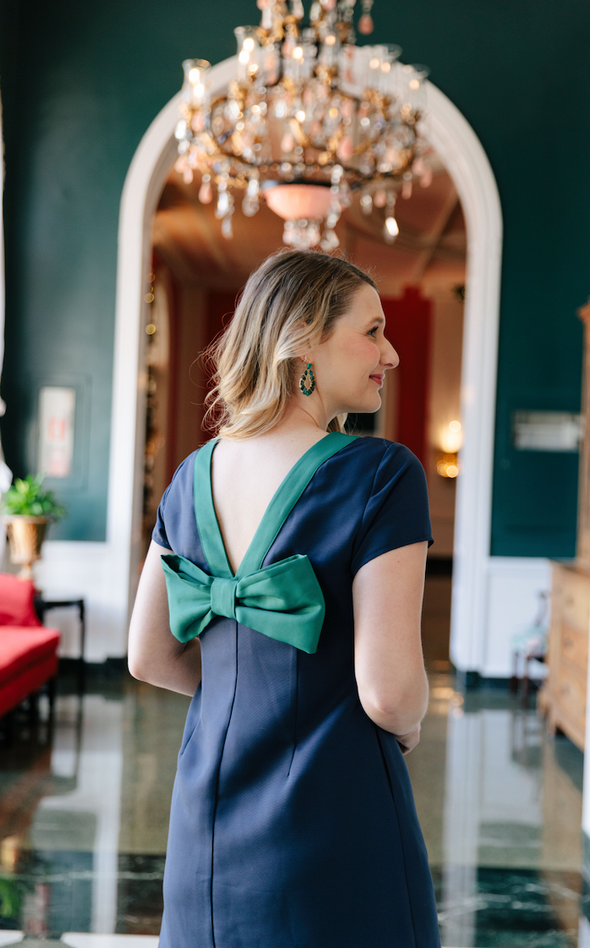 Cropped back view of model in Sail to Sable Allie Bow Back Dress - Navy
