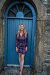 Model against blue door wearing Gretchen Scott Dapper Dress - Duke Of York - Black/Multi