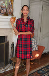 Model enjoying a drink in the Gretchen Scott Ruff Neck Dress in Plaidly Cooper Red Plaid