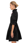 Side view of the Gretchen Scott Teardrop Dress - Faille - Black