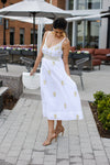 Model outside wearing Gretchen Scott Fiesta Time Dress in White/Gold