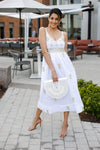 Model in courtyard wearing Gretchen Scott Fiesta Time Dress in White/Gold