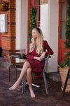 Sitting view of Sail to Sable Highlands Dress - Red Plaid