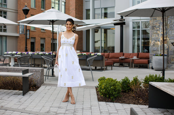 Model at restaurant wearing Gretchen Scott Fiesta Time Dress in White/Gold