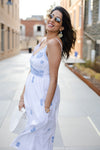 Side view of Gretchen Scott Fiesta Time Dress in White/Periwinkle with model hands in pockets