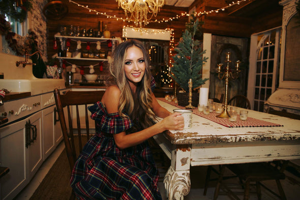 Model seated in kitchen in The Holly Dress