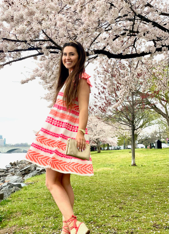 Outdoor side view of Sail to Sable Flutter Sleeve Fit & Flare Dress - Pink/Orange